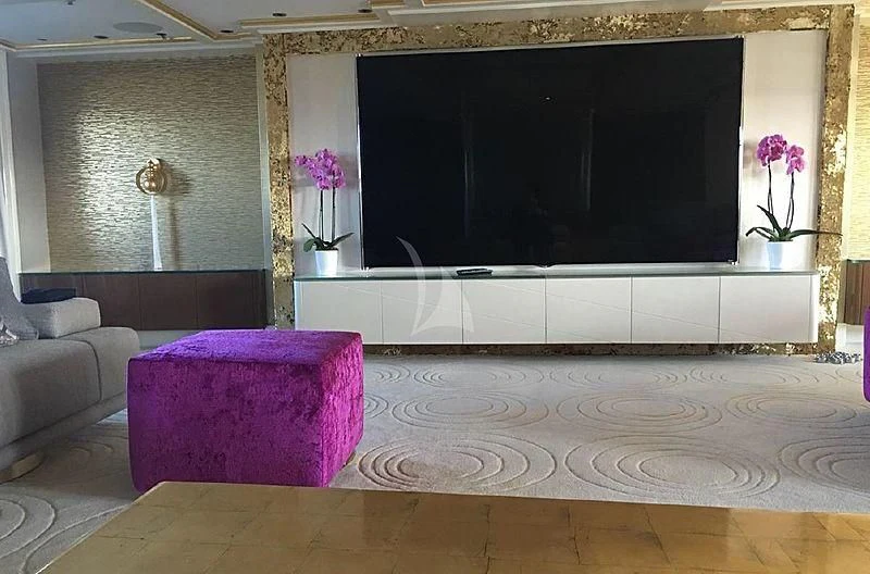 a living room with a large television aboard ELEGANT 007 Yacht for Sale