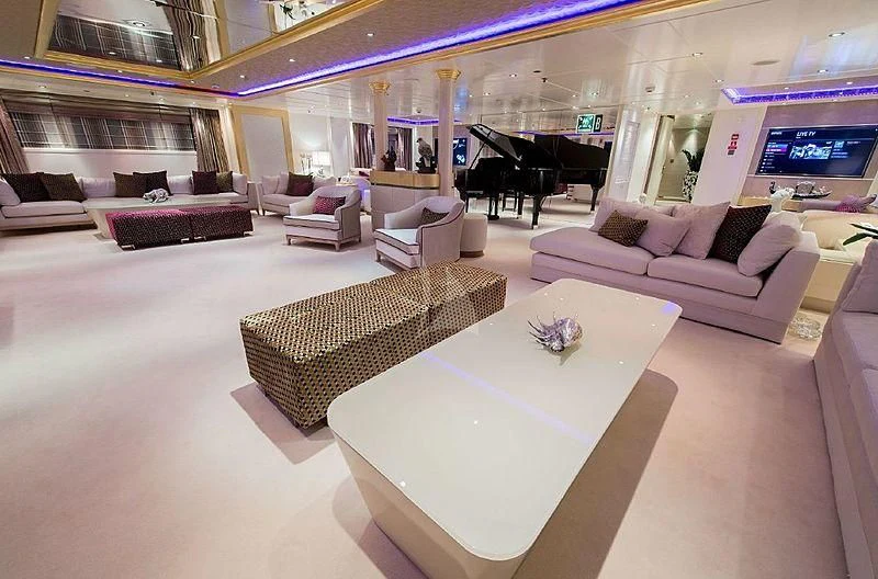 a living room with a piano and a table aboard ELEGANT 007 Yacht for Sale