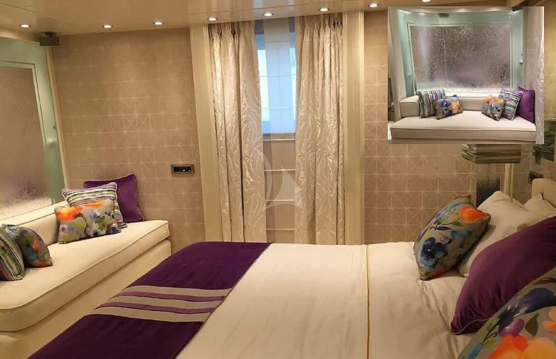 a bedroom with a bed and a window aboard ELEGANT 007 Yacht for Sale