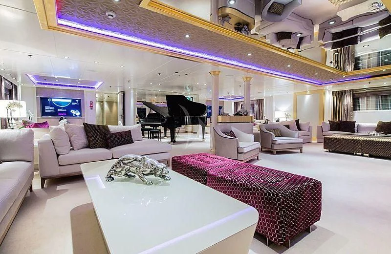 a large living room with a large pink and white table and chairs aboard ELEGANT 007 Yacht for Sale