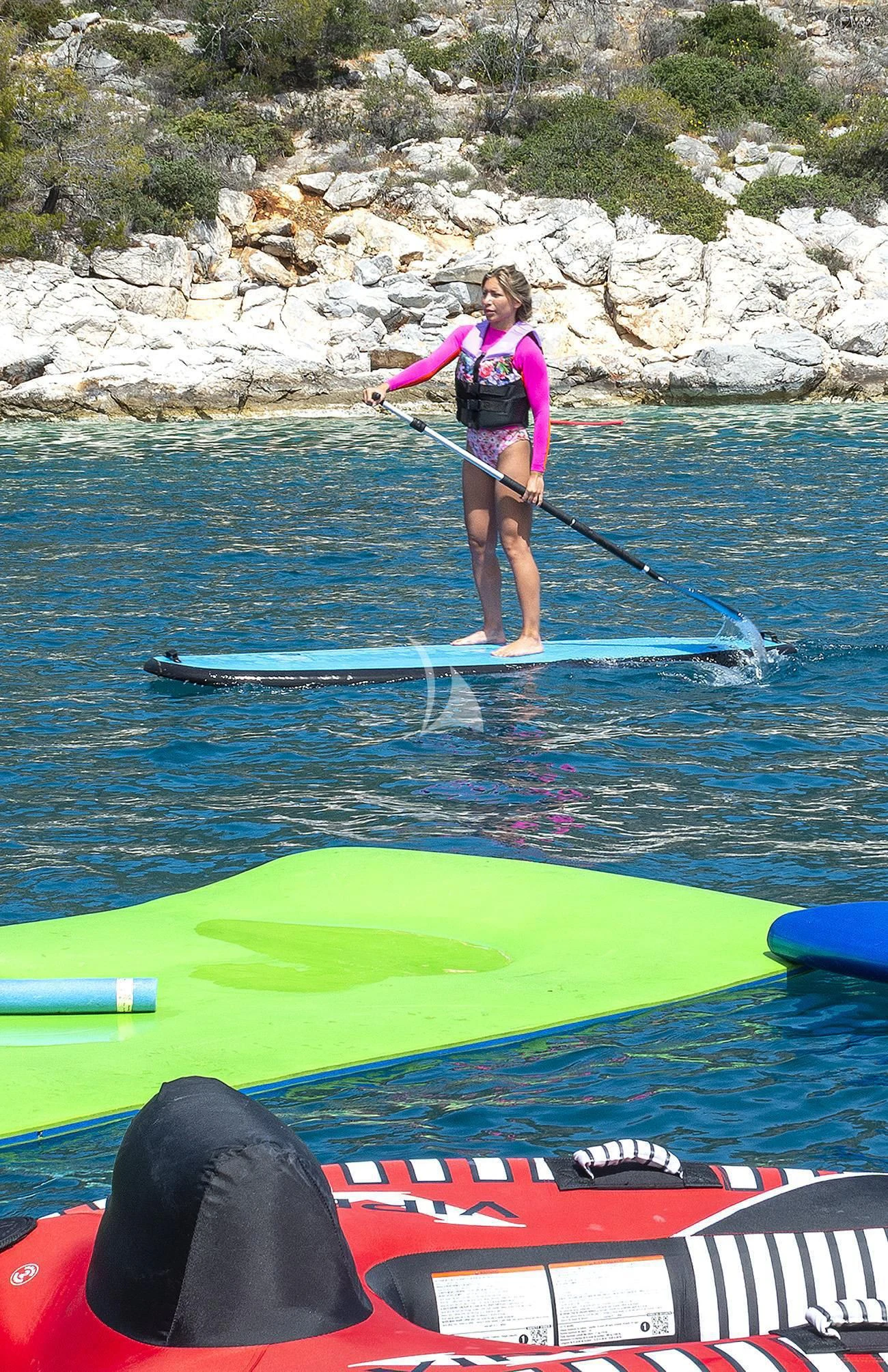 a woman on a paddle board aboard FATSA Yacht for Sale