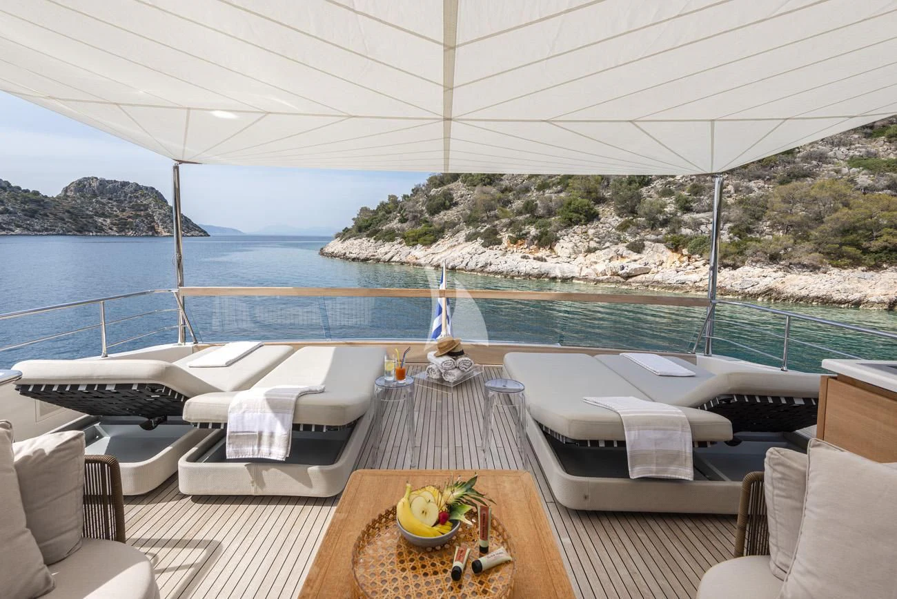 a deck with a view of the ocean and a large city aboard FATSA Yacht for Sale