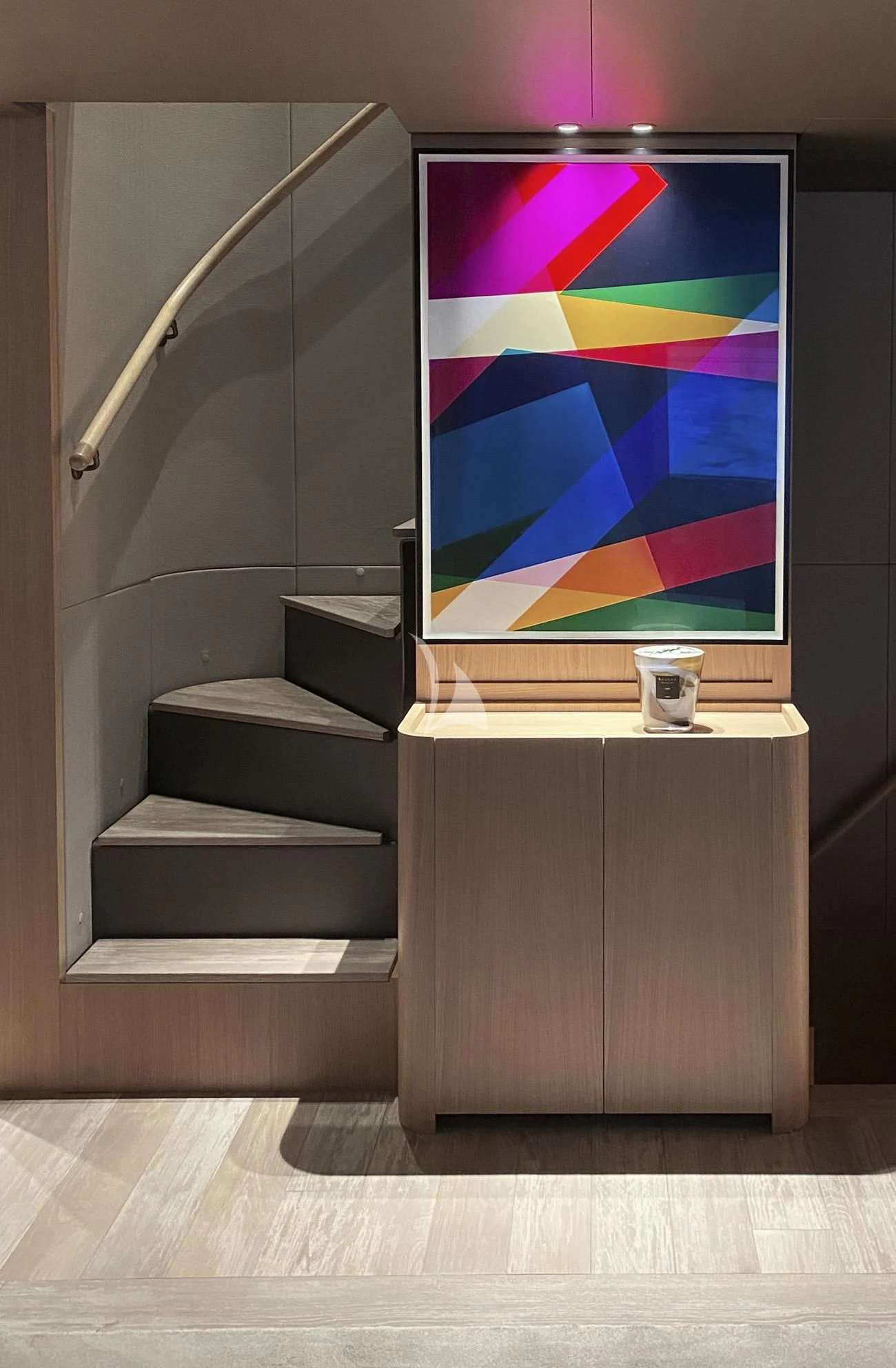 a staircase with a painting on the wall aboard FATSA Yacht for Sale