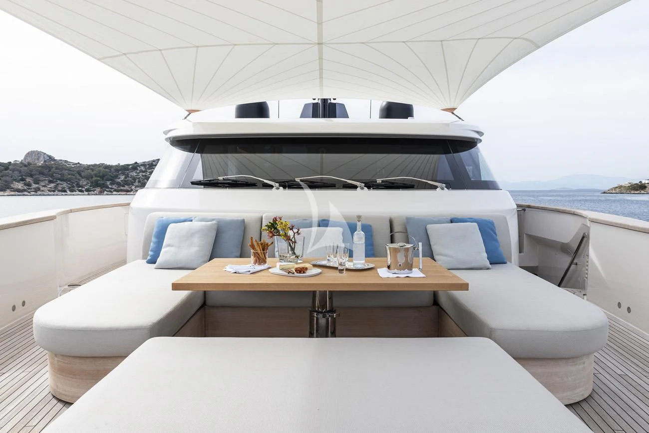 a white lounge chair in a room with a table and chairs aboard FATSA Yacht for Sale