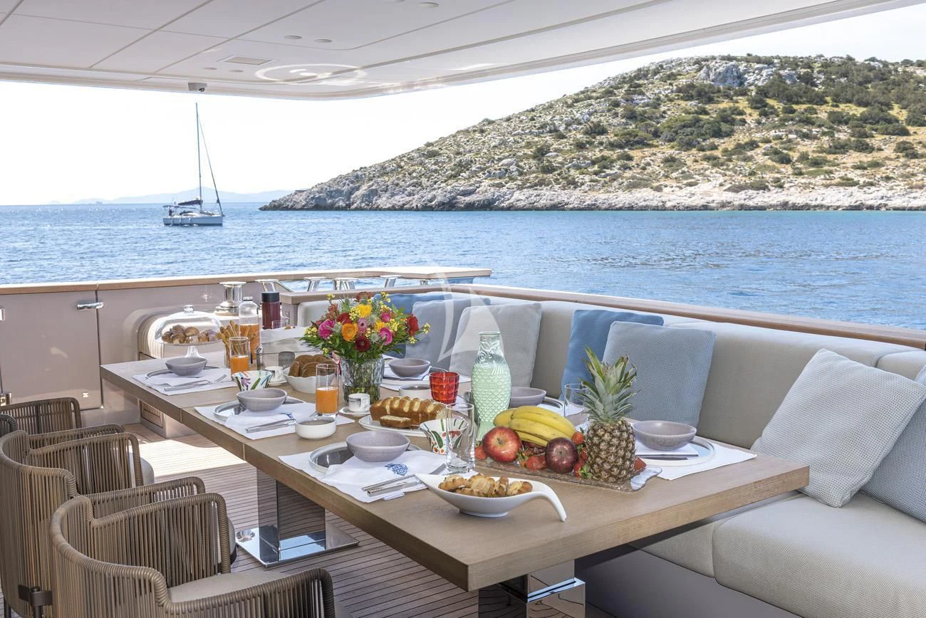 a table with food and drinks on it by a body of water aboard FATSA Yacht for Sale