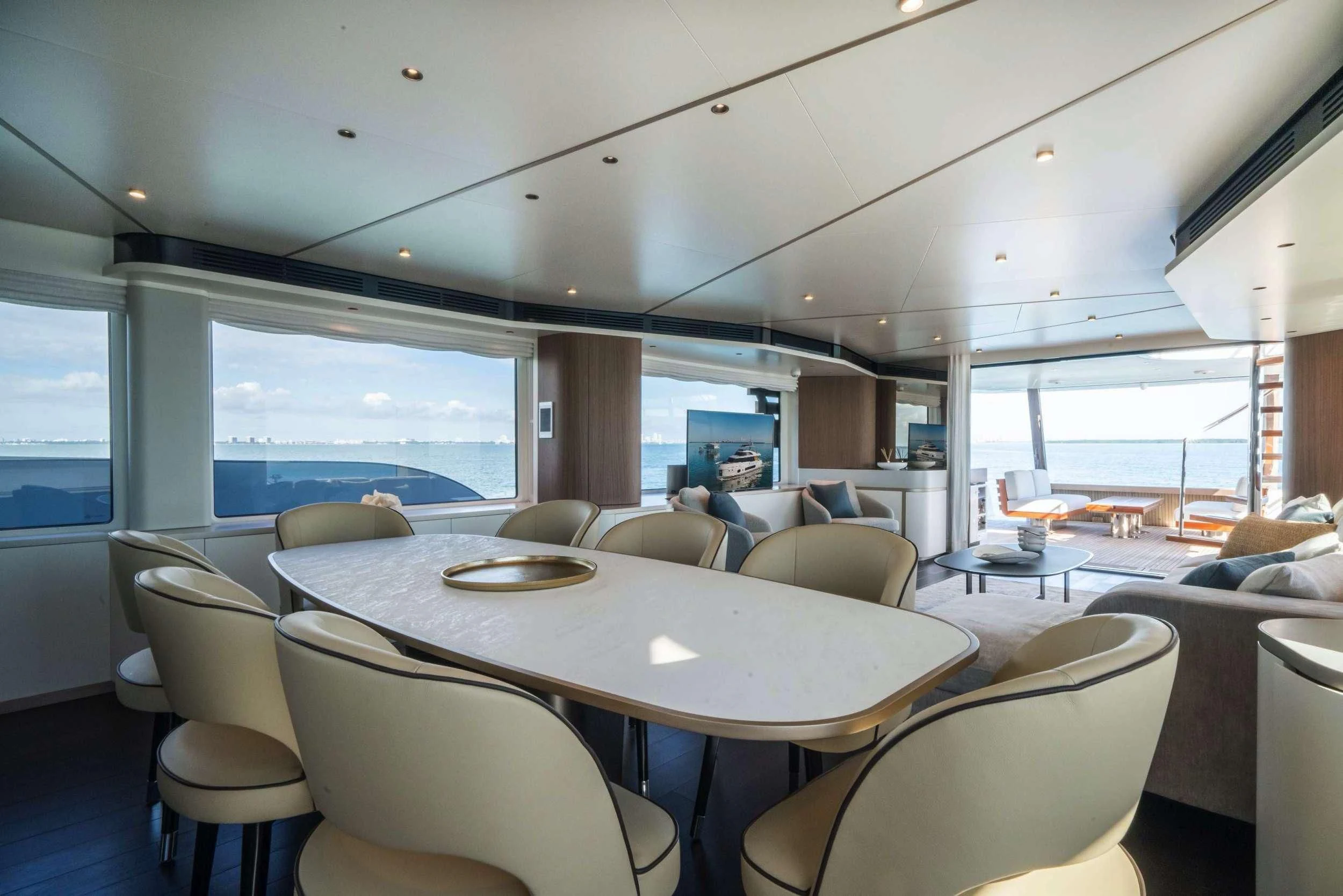 a dining room with a large window aboard GUBA TIMES Yacht for Charter