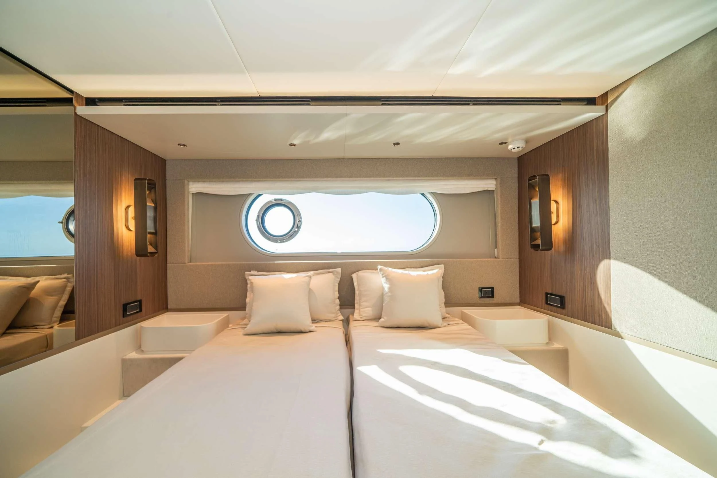 a room with beds and a large window aboard GUBA TIMES Yacht for Charter