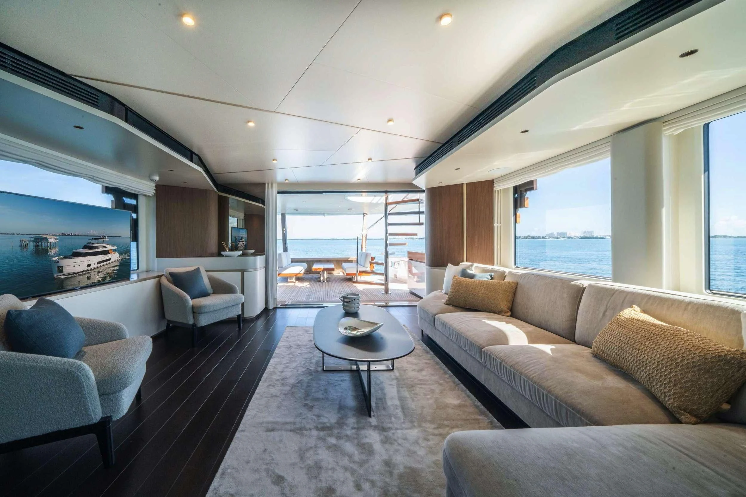 a living room with a large window aboard GUBA TIMES Yacht for Charter
