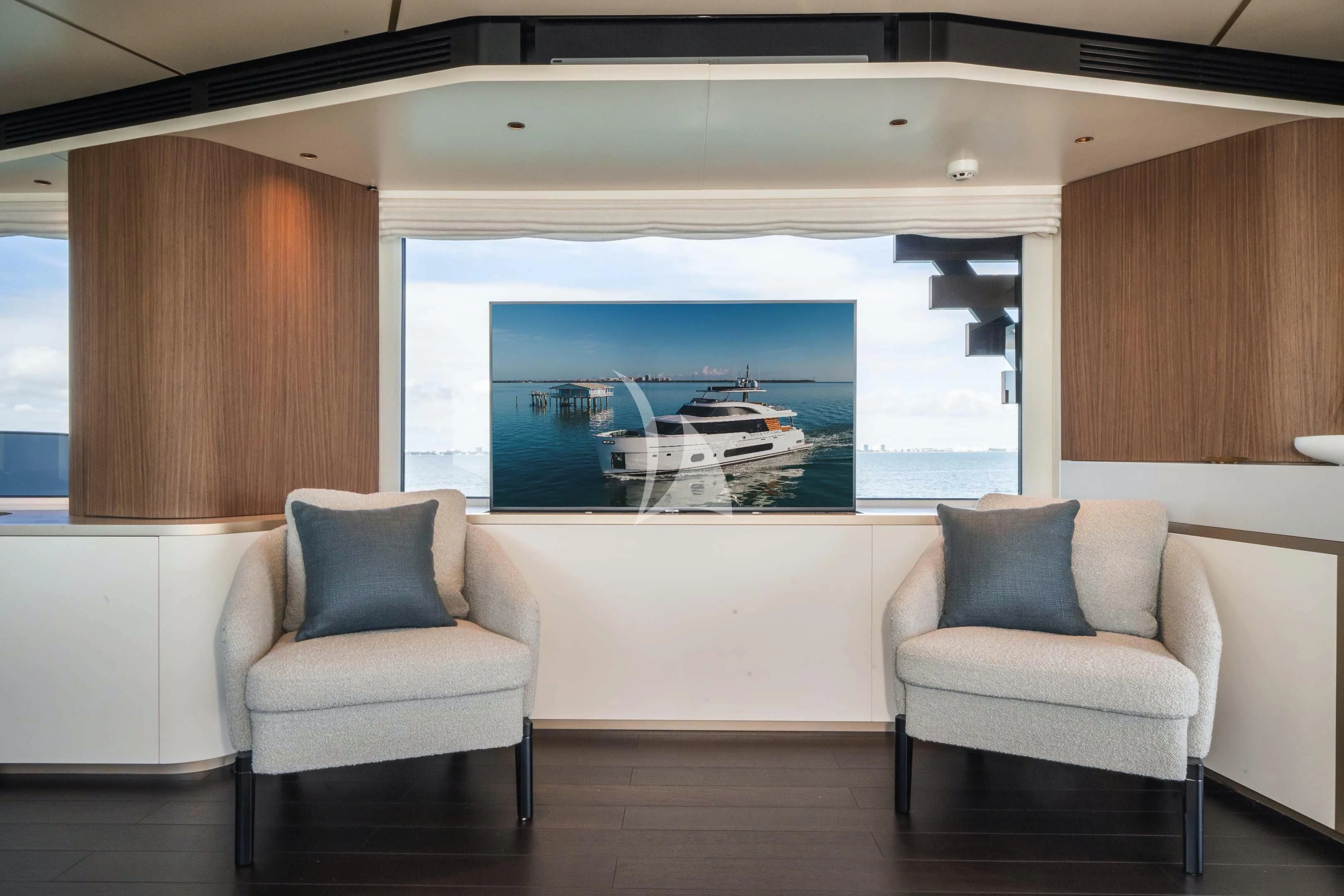a room with a couch and a large window aboard GUBA TIMES Yacht for Charter