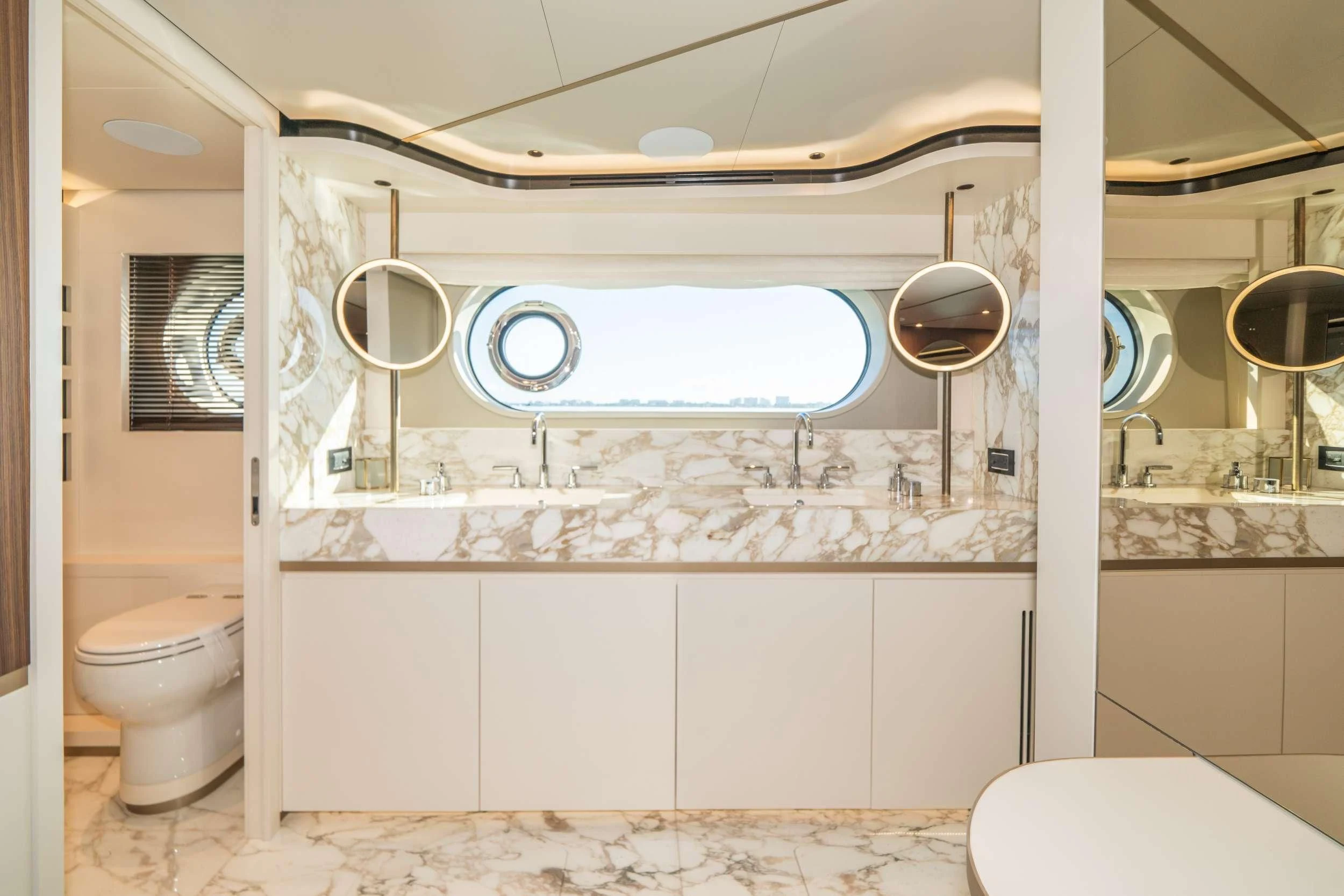 a bathroom with a large window aboard GUBA TIMES Yacht for Charter