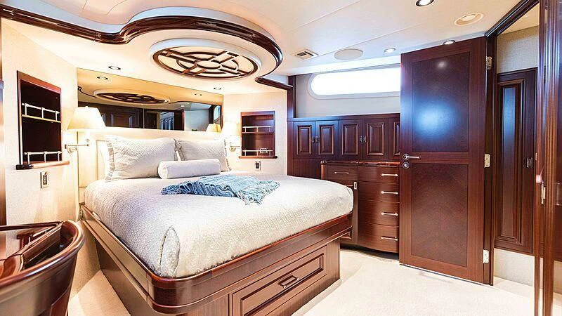 a bedroom with a bed and a dresser aboard AMAZING GRACE Yacht for Sale