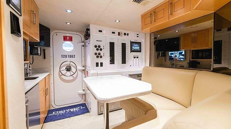 a kitchen with a table and a refrigerator aboard AMAZING GRACE Yacht for Sale