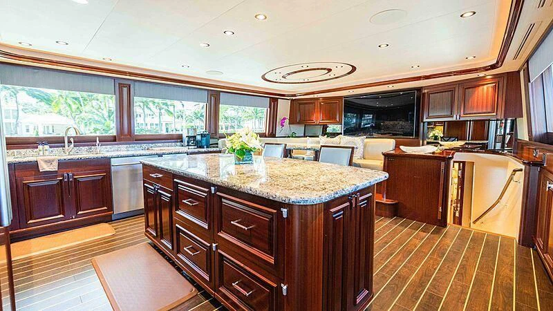 a large kitchen with wooden cabinets aboard AMAZING GRACE Yacht for Sale