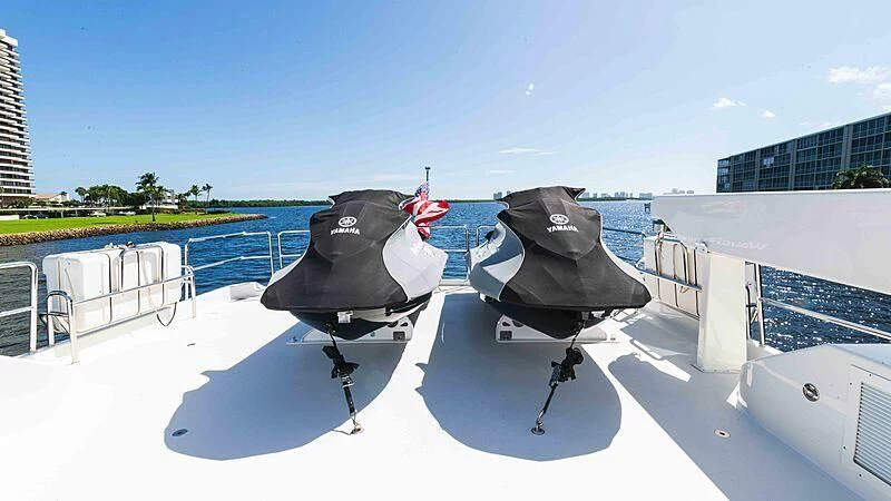 a couple of black chairs on a white railing with a building in the background aboard AMAZING GRACE Yacht for Sale