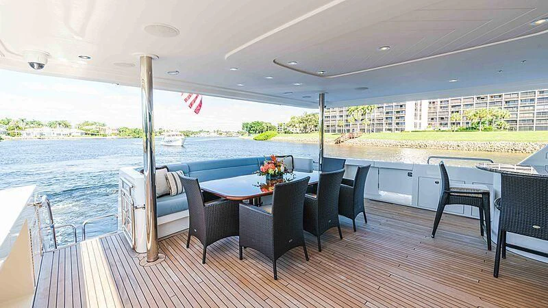 a large patio with a table and chairs and a large body of water aboard AMAZING GRACE Yacht for Sale