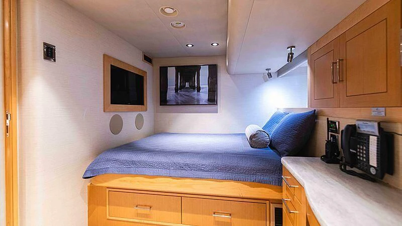 a bedroom with a bed and a desk aboard AMAZING GRACE Yacht for Sale