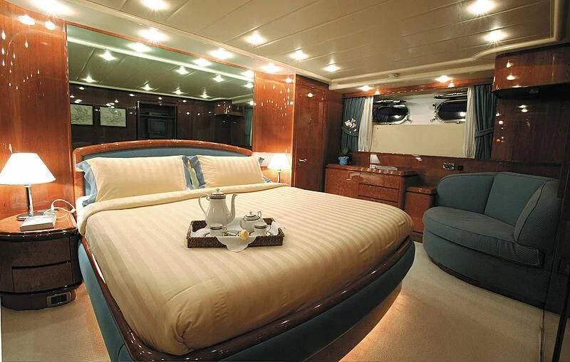 a hotel room with a bed and a couch aboard MONTE CARLO Yacht for Sale