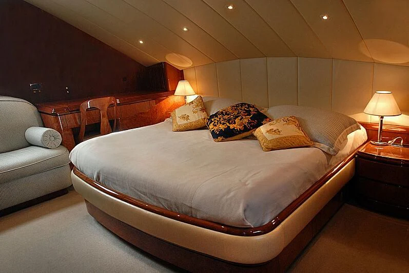 a bed with a white comforter aboard MONTE CARLO Yacht for Sale