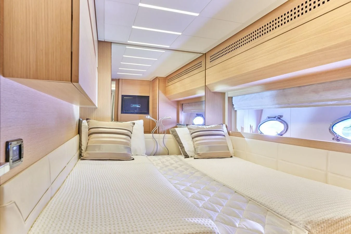 a room with a bed and a television aboard HIT Yacht for Sale