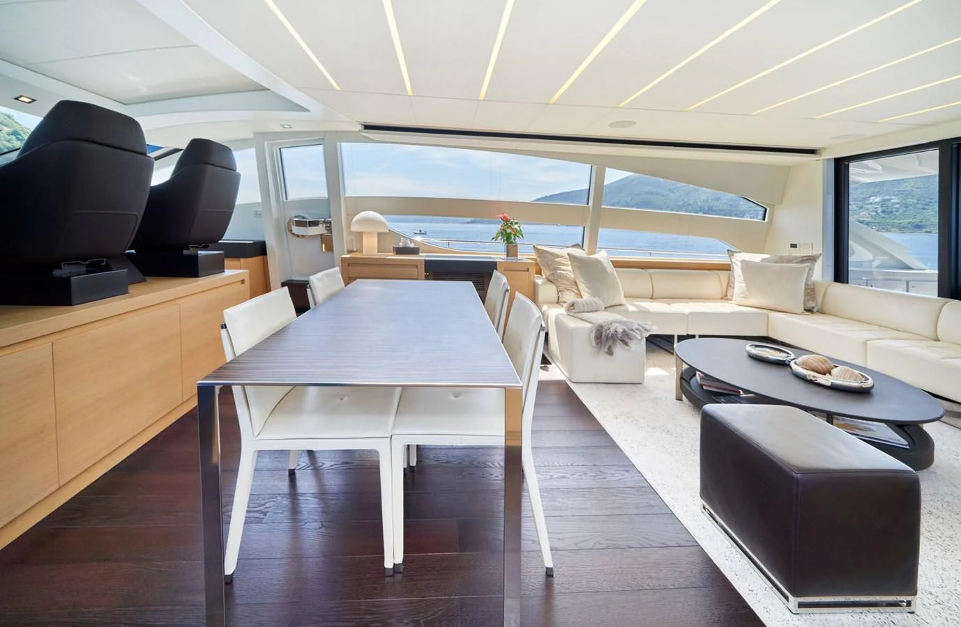 a room with a table and chairs aboard HIT Yacht for Sale