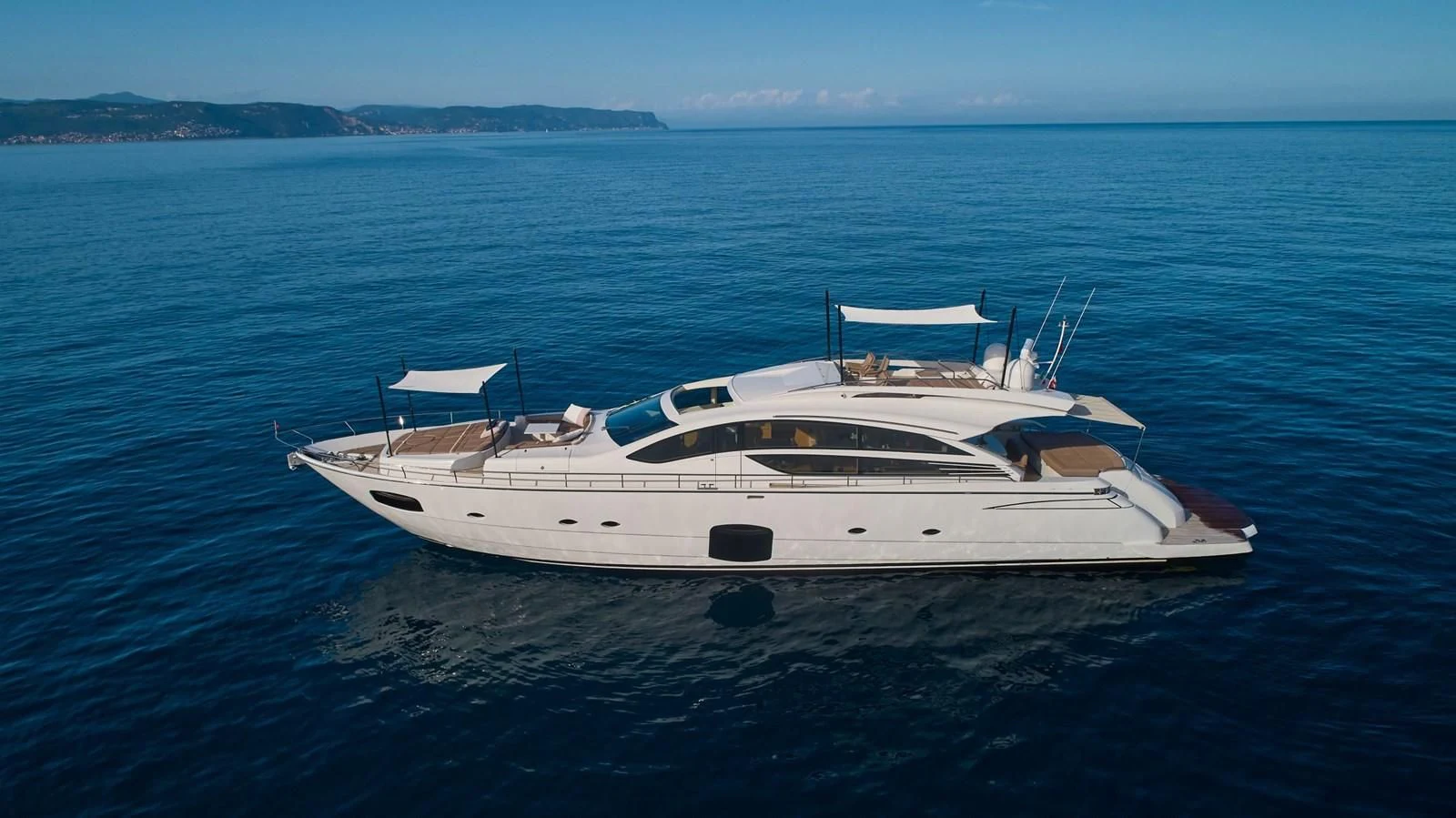 a white boat in the water aboard HIT Yacht for Sale