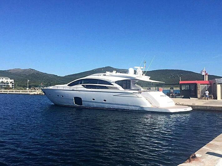 a white yacht in a harbor aboard HIT Yacht for Sale