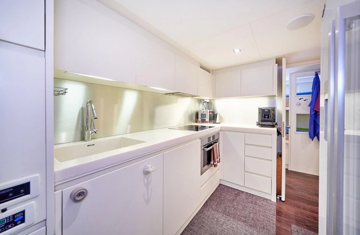 a kitchen with white cabinets aboard HIT Yacht for Sale
