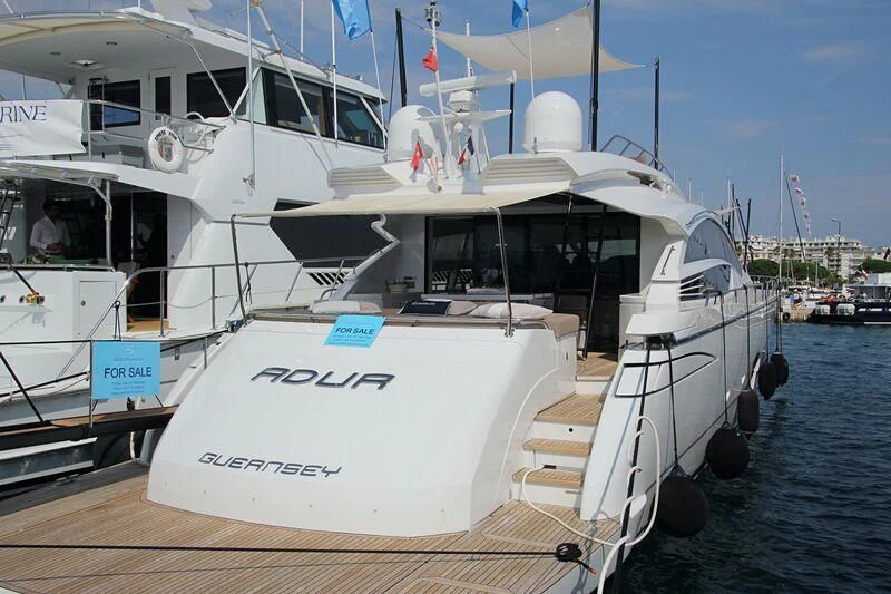 a boat docked at a pier aboard HIT Yacht for Sale