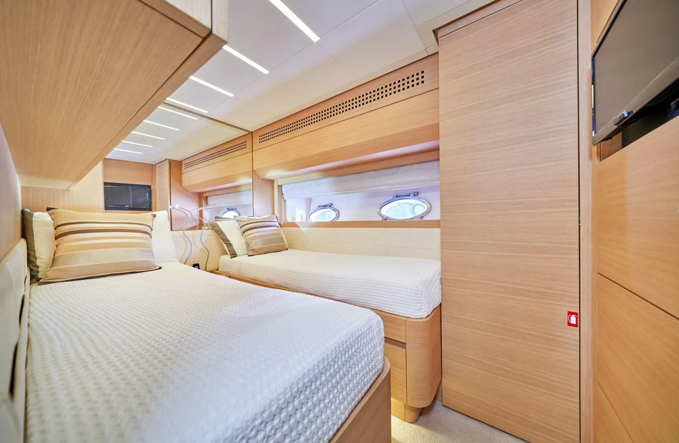 a room with a couple of beds aboard HIT Yacht for Sale
