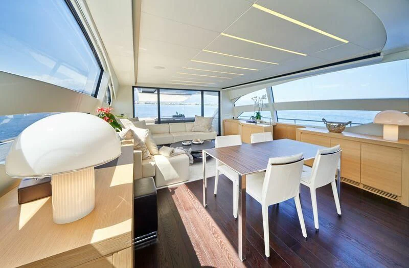 a room with a table and chairs aboard HIT Yacht for Sale