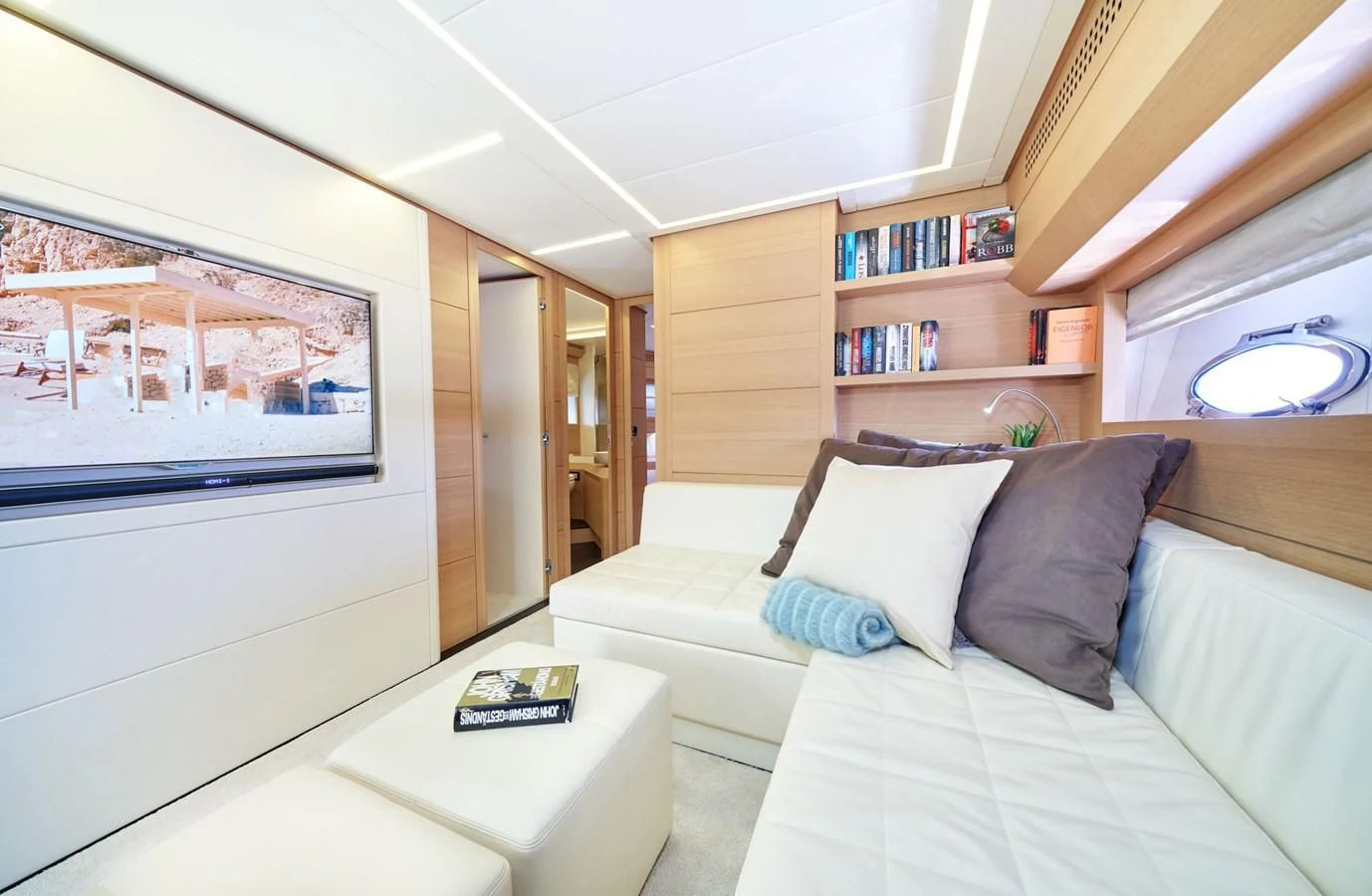 a room with a bed and a bookcase aboard HIT Yacht for Sale