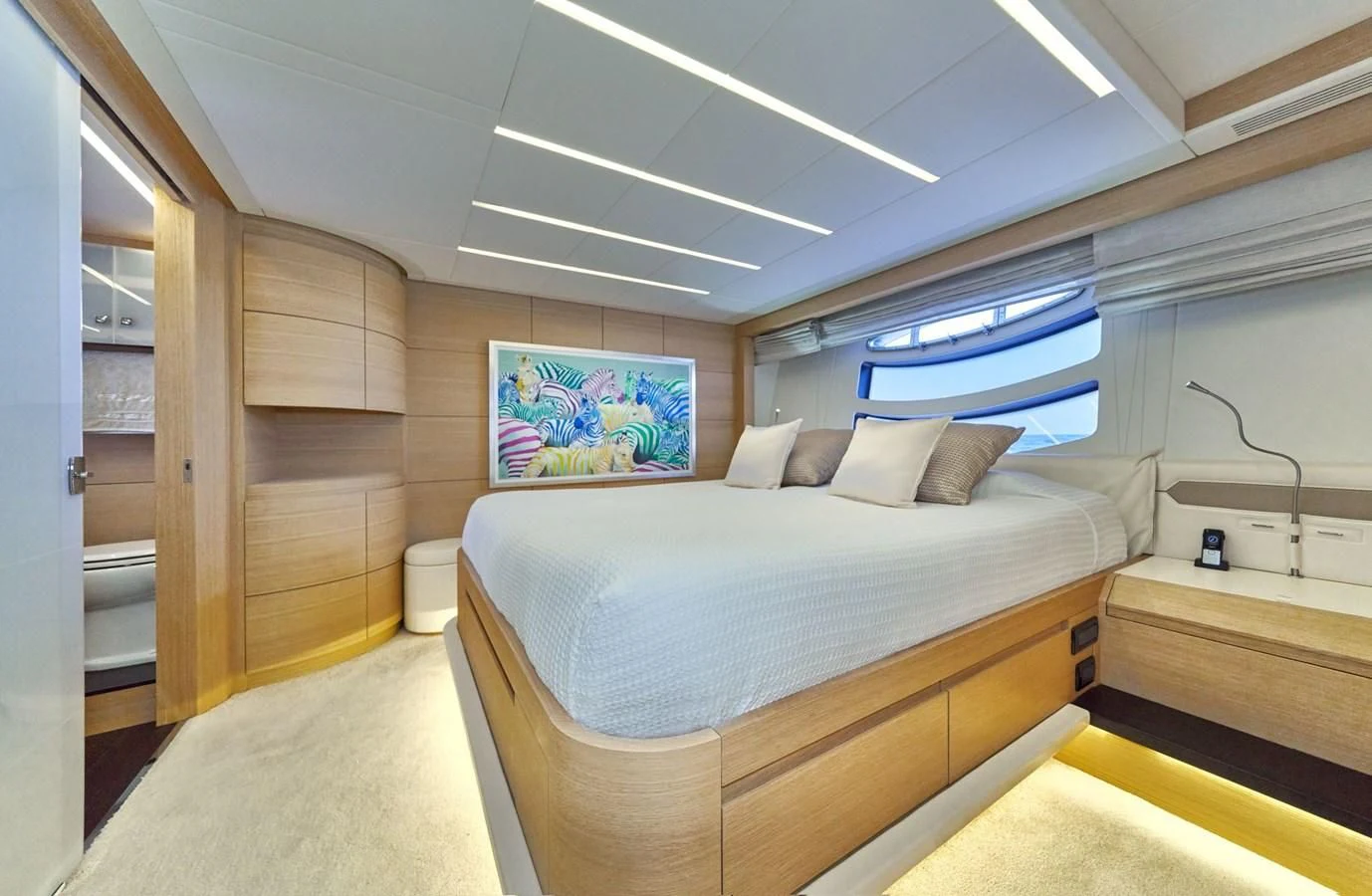 a room with a bed and a window aboard HIT Yacht for Sale