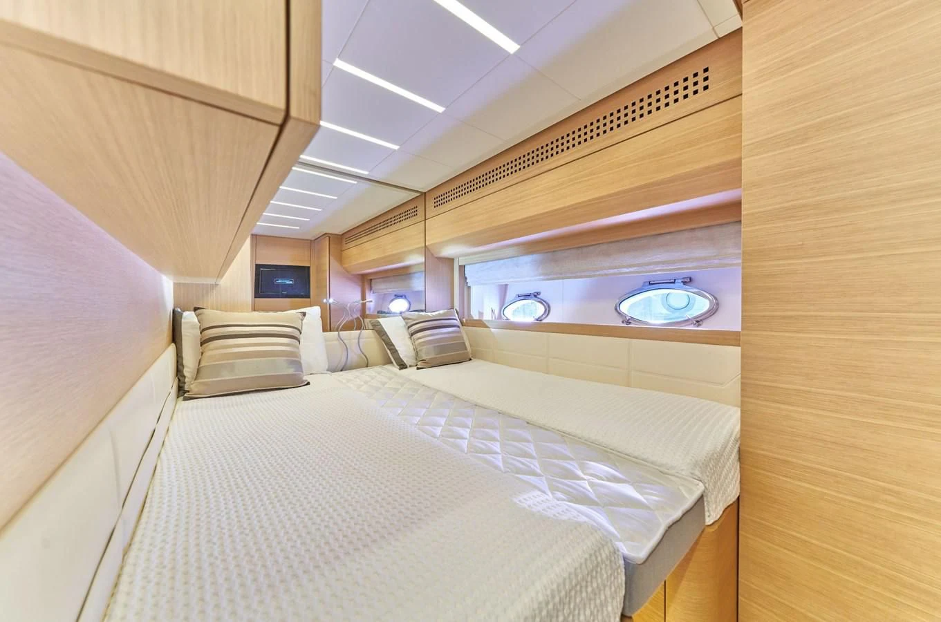 a room with a bed and a large mirror aboard HIT Yacht for Sale