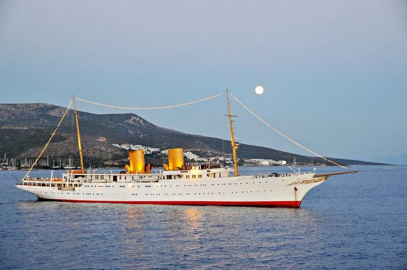 a large ship in the water aboard SAVARONA Yacht for Sale