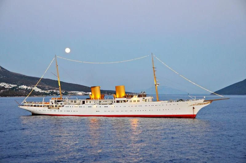 a large ship in the water aboard SAVARONA Yacht for Sale