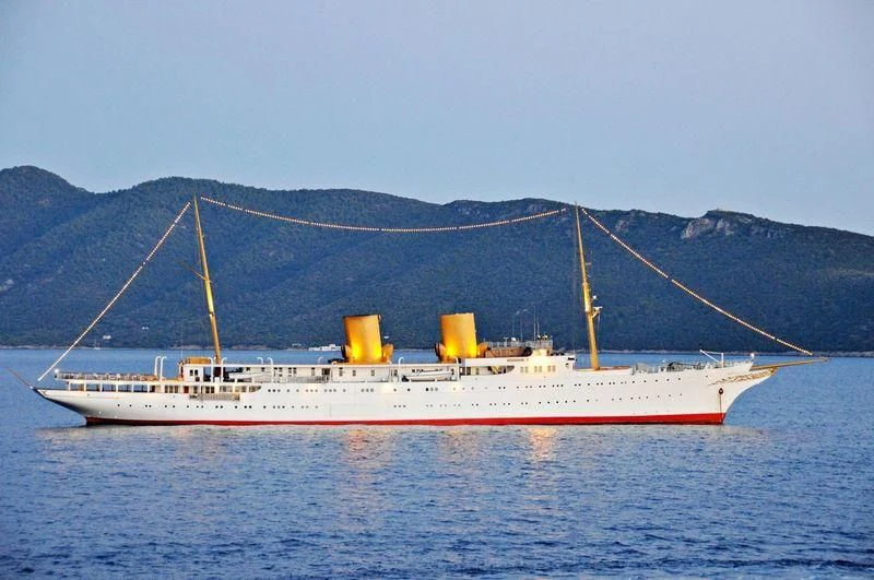a large white ship in the water aboard SAVARONA Yacht for Sale