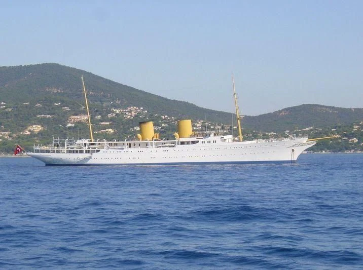 a large white ship in the water aboard SAVARONA Yacht for Sale