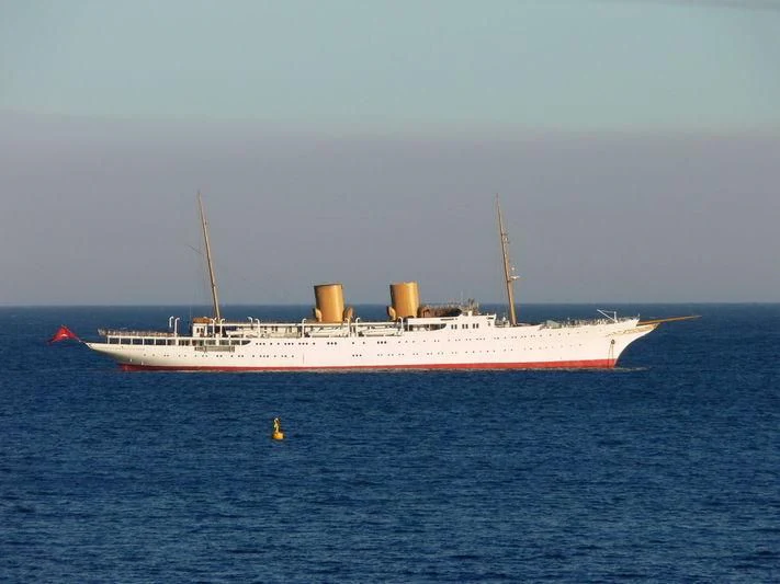 a large white ship in the water aboard SAVARONA Yacht for Sale