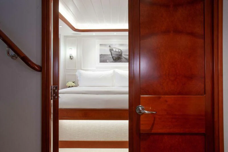 a room with a bed and a mirror aboard BRAVEHEART Yacht for Sale