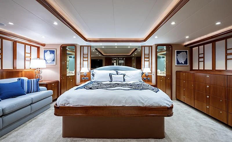a large bedroom with a bed and a desk aboard BRAVEHEART Yacht for Sale