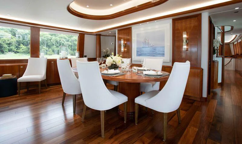 a large room with a table and chairs aboard BRAVEHEART Yacht for Sale