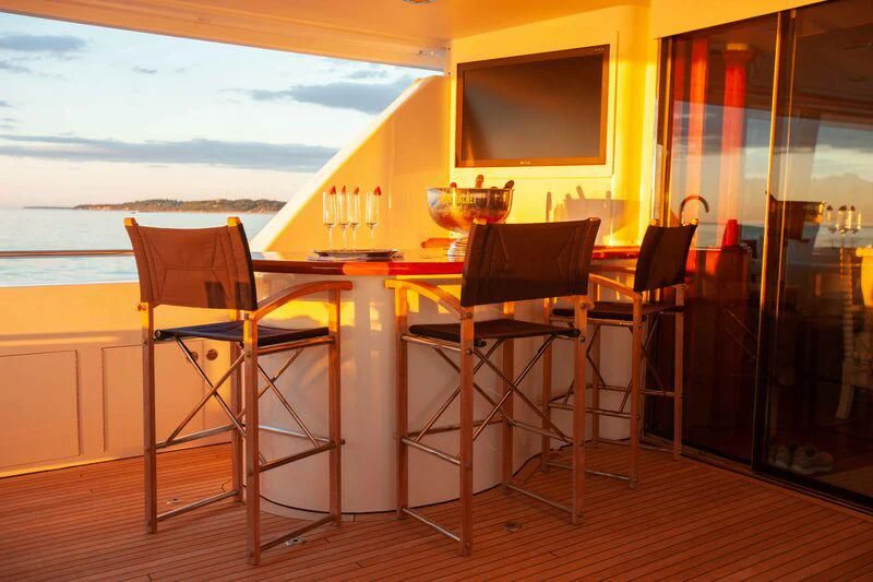 a table and chairs in a room aboard BRAVEHEART Yacht for Sale