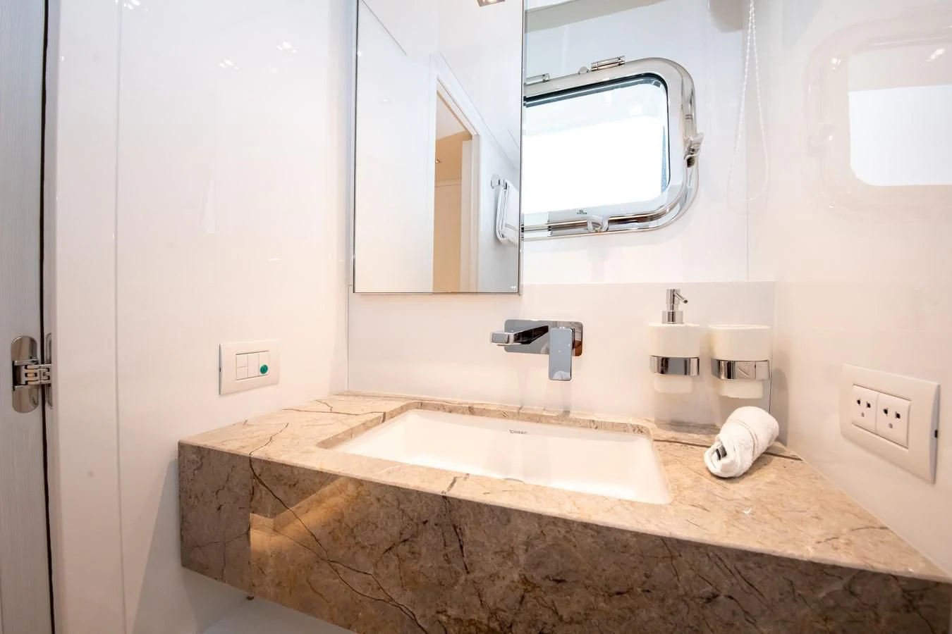 a bathroom with a countertop sink and mirror aboard MARAVI Yacht for Sale
