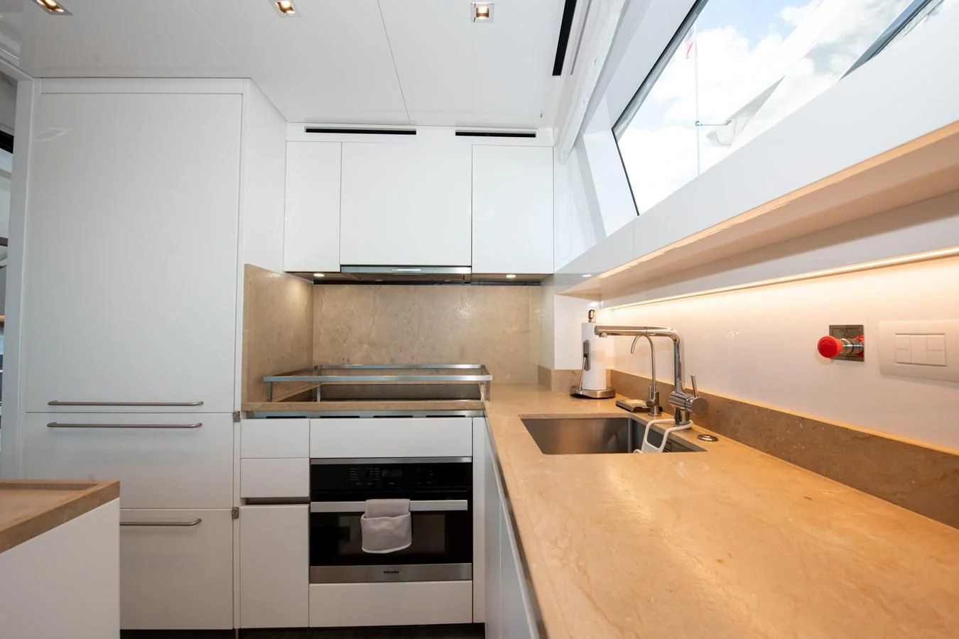 a kitchen with white cabinets aboard MARAVI Yacht for Sale