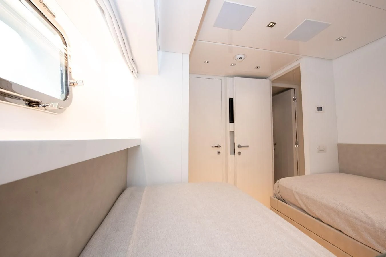 a bedroom with a bed and a window aboard MARAVI Yacht for Sale
