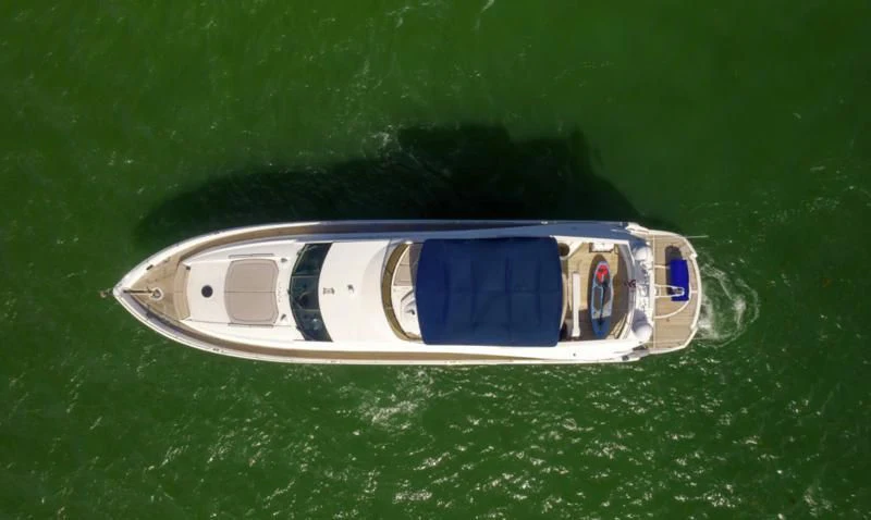 a small boat on the water aboard FINS UP Yacht for Sale