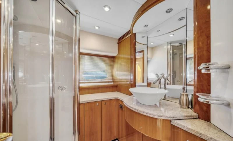 a bathroom with a sink and a mirror aboard FINS UP Yacht for Sale