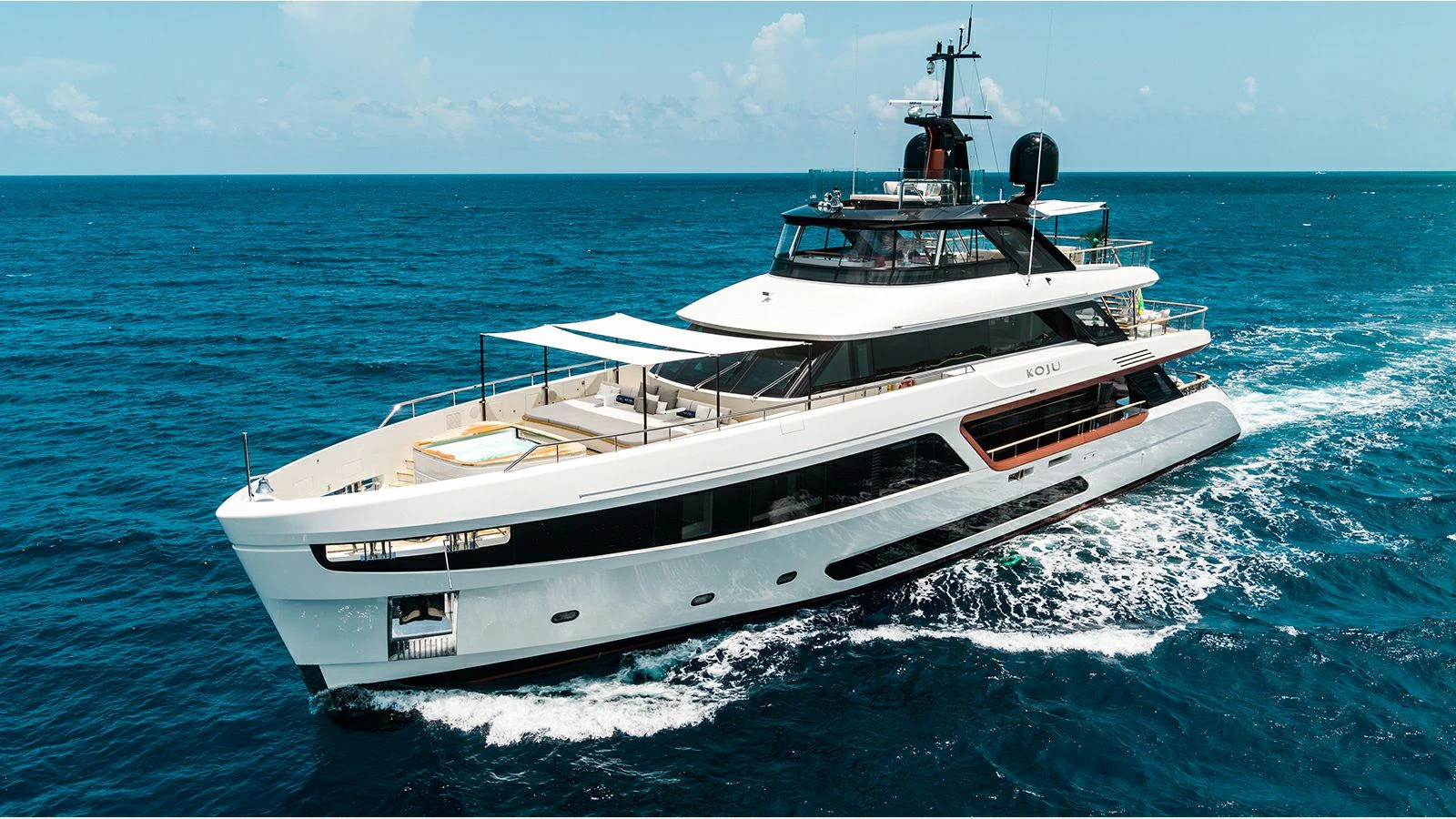 a white boat on the water aboard KOJU Yacht for Sale