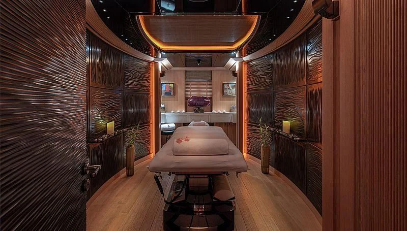 a room with a bed and a table aboard KOJU Yacht for Sale