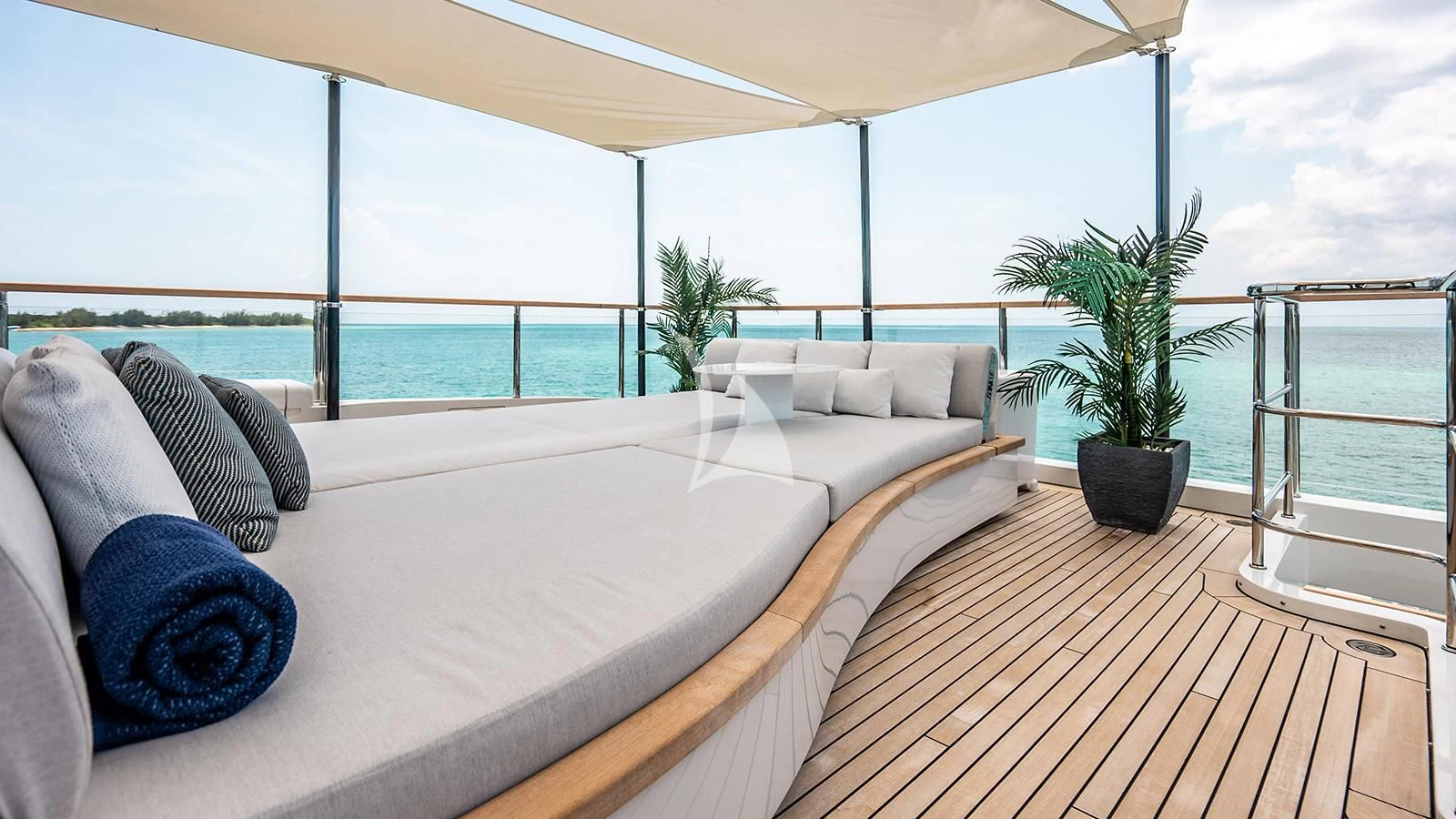 a large bed with a plant on the side aboard KOJU Yacht for Sale